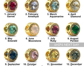 May include: Twelve gold charms, each featuring a different gemstone, representing the twelve months of the year. The charms are arranged in four rows of three, with the month and gemstone name listed below each charm.