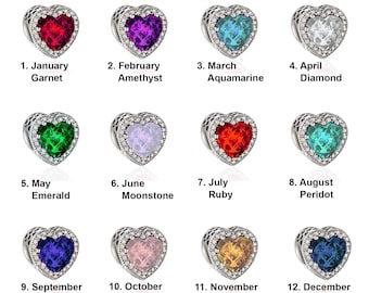 May include: Twelve silver heart-shaped charms with different coloured gemstones, each representing a different month of the year. The charms are arranged in four rows of three, with the month and gemstone name listed below each charm.