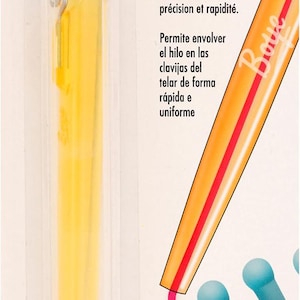 May include: A yellow Boye Loom Pen Tool in a clear plastic package. The tool is designed for wrapping loom pegs smoothly and quickly. The packaging includes text in English and Spanish.