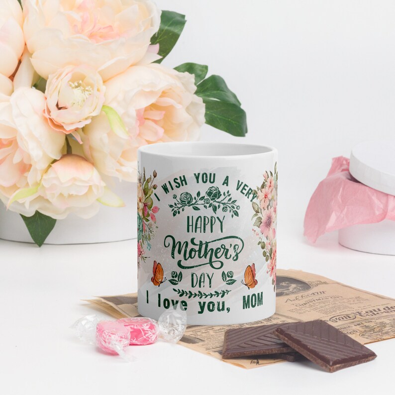 May include: White ceramic mug with a floral design and the text "I wish you a very happy Mother's Day I love you, MOM".