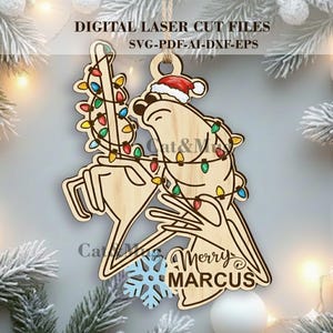 May include: Wooden Christmas ornament depicting a reindeer in a Santa hat, adorned with colourful string lights. The ornament reads "Merry MARCUS" and is designed for laser cutting. The ornament is a light brown colour.