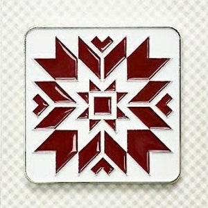 May include: A white enamel needle minder with a red barn star design. The needle minder features the text "Barn Star Primrose Cottage" and "Enamel Needle Minder".