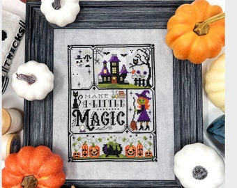 May include: A cross-stitch pattern featuring a black cat, a witch, a haunted house, and pumpkins. The text reads "Make a little magic".