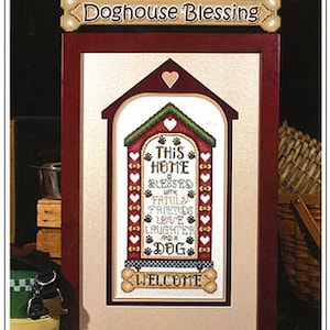 May include: Cross stitch pattern for a doghouse with the text "This home is blessed with family, friends, love, laughter and a dog. Welcome". The pattern is framed in a red wooden frame with a beige mat.