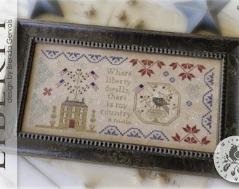 May include: A cross-stitch embroidery design titled "Liberty" by Brenda Gervais. The design features a house with a red door, a tree with red, white, and blue flags, and a bird in a nest. The text "Where liberty dwells, there is my country. B. Franklin" is included in the design.