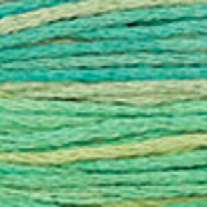 May include: A skein of yarn with a green and yellow ombre color pattern. The yarn is soft and textured, perfect for knitting or crocheting.