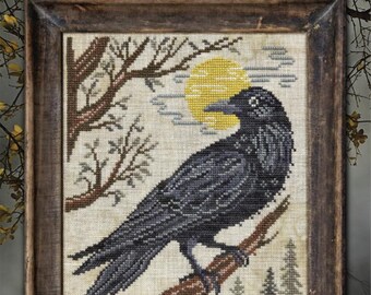 May include: Cross-stitch sampler titled "The Crow" in a wooden frame. The artwork depicts a black crow perched on a branch, with a yellow moon and trees in the background. The text "A Year in the Woods II #4" is at the top.