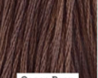 May include: A spool of brown embroidery floss labeled "Cocoa Bean".