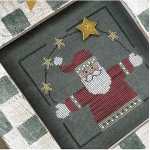 May include: A cross-stitch design featuring a jolly Santa Claus with a red and white sweater, a white beard, and a red hat. He is surrounded by a string of gold stars on a green background.