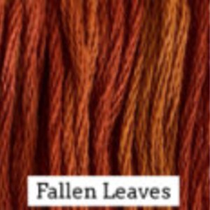 May include: A skein of embroidery floss in shades of orange, red, and brown. The floss is labeled "Fallen Leaves".