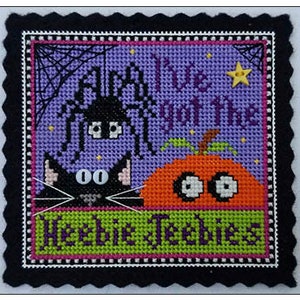 May include: Cross stitch pattern featuring a black cat, a pumpkin, and a spider with the text "All I've got are the heebee jeebees".