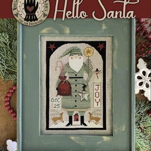 May include: A cross stitch pattern featuring a cartoon Santa Claus holding a bag of gifts and a sign that says "JOY". The pattern is framed in a green frame with a distressed finish. The title "Hello Santa" is written in red at the top of the frame.