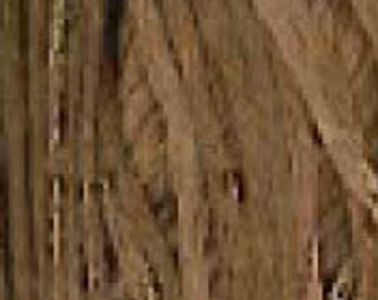 May include: A close-up of a brown, textured, woven fabric. The fabric has a natural, rustic look and feel.