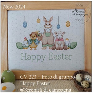 May include: Cross-stitch embroidery in a wooden frame features a bunny, chick, and lamb with Easter eggs. The text "Happy Easter" is stitched below the figures. The frame is set against a light background. The text "New 2024" is in the upper left corner.