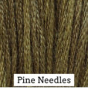 May include: Close-up of a spool of green embroidery floss with the text "Pine Needles" printed on the label.
