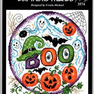 May include: A cross-stitch pattern titled BOO-TASTIC FRIENDS 3574 designed by Ursula Michael. The circular design features three orange jack-o'-lanterns, a green witch hat, a purple letter B, and two green O's with eyes, surrounded by ghosts, bats, and a spider web.
