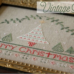 May include: Cross-stitch pattern of a vintage Christmas tree with the text "Merry Christmas" and the design number "OH1253".