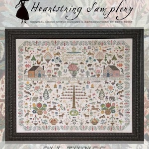 May include: Framed cross-stitch sampler with a black frame. The sampler features a detailed design with houses, animals, and floral elements. Text at the top reads "Heartstring Samplery" and "Original Cross Stitch Designs & Reproductions by Beth Twist." The bottom text says "All Things Wise + Wonderful."