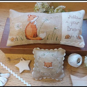 May include: Two embroidered pillow covers with a fox and dandelion design. The larger pillow has the text "Follow your Dreams" on the right side. The smaller pillow has a fox face in the center.