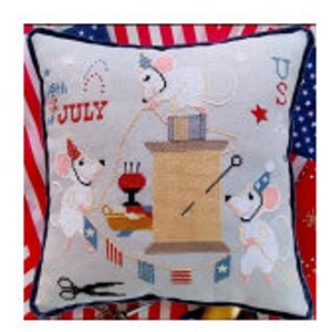 May include: A white pillow with a red, white, and blue American flag design. Three white mice wearing party hats are sewing a red, white, and blue banner that says "4th of JULY".