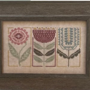 May include: Three stylized floral designs in a framed cross-stitch pattern. The flowers are in shades of pink, red, and blue with green leaves.