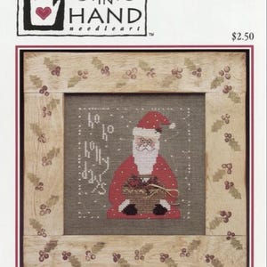 May include: Cross stitch pattern featuring a cartoon Santa Claus holding a basket of gifts. The pattern is titled "Wee Santa '96" and is from the "Heart in Hand Needleart" collection. The pattern is designed by Cecilia Turner.