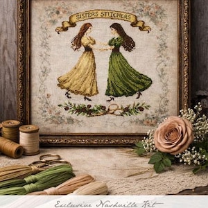 May include: Framed cross-stitch art featuring two women in flowing dresses, holding hands. The artwork is in a decorative gold frame. The text "SISTERS STITCHERS" is displayed above the image. The image is part of the 2026 Nashville Collection.