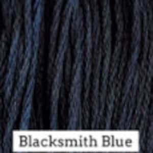 May include: A close-up of a dark blue yarn with a subtle color variation, called "Blacksmith Blue".