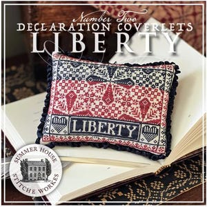 May include: A decorative pillow with the word "LIBERTY" embroidered in a patriotic red, white, and blue design. The pillow is rectangular with a ruffled black border and rests on an open book. The text "Number Two Declaration Coverlets" is above the pillow.
