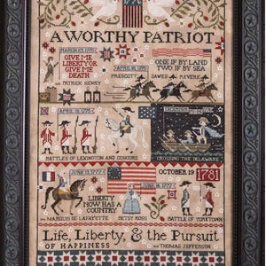 May include: A framed cross-stitch sampler with a patriotic theme. The artwork features historical figures, dates, and phrases like "Give me liberty or give me death." The color palette includes beige, red, blue, and green.
