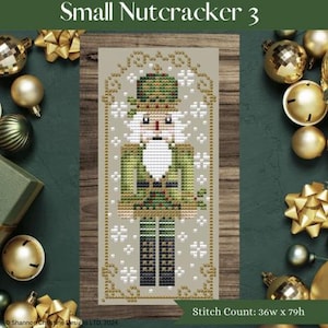 May include: A cross-stitch pattern of a nutcracker soldier in green and white, with the text "Small Nutcracker 3". The stitch count is 36w x 79h. The design is surrounded by gold Christmas ornaments and bows.