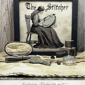 May include: A black and white cross-stitch pattern of a woman sitting in a chair and sewing. The title "The Stitcher" is above the image. The image is framed in black and surrounded by various sewing supplies.