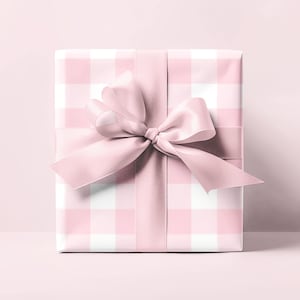 May include: A pink and white gingham gift box with a large pink satin bow.