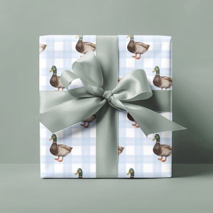 May include: A blue and white gingham gift wrap with a green ribbon and a pattern of brown ducks.