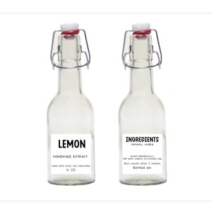 May include: Two clear glass bottles with swing-top closures. One bottle has a label that reads "LEMON HOMEMADE EXTRACT" and "6 OZ." The other bottle's label says "INGREDIENTS lemons, vodka." Both labels include additional text.