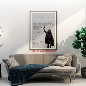 May include: A minimalist poster featuring a black and white image of a man raising his fist in the air. The poster has a gray background and the text "The Breakfast Club" in black. The text "FRAME NOT INCLUDED" is printed in red at the bottom of the poster.