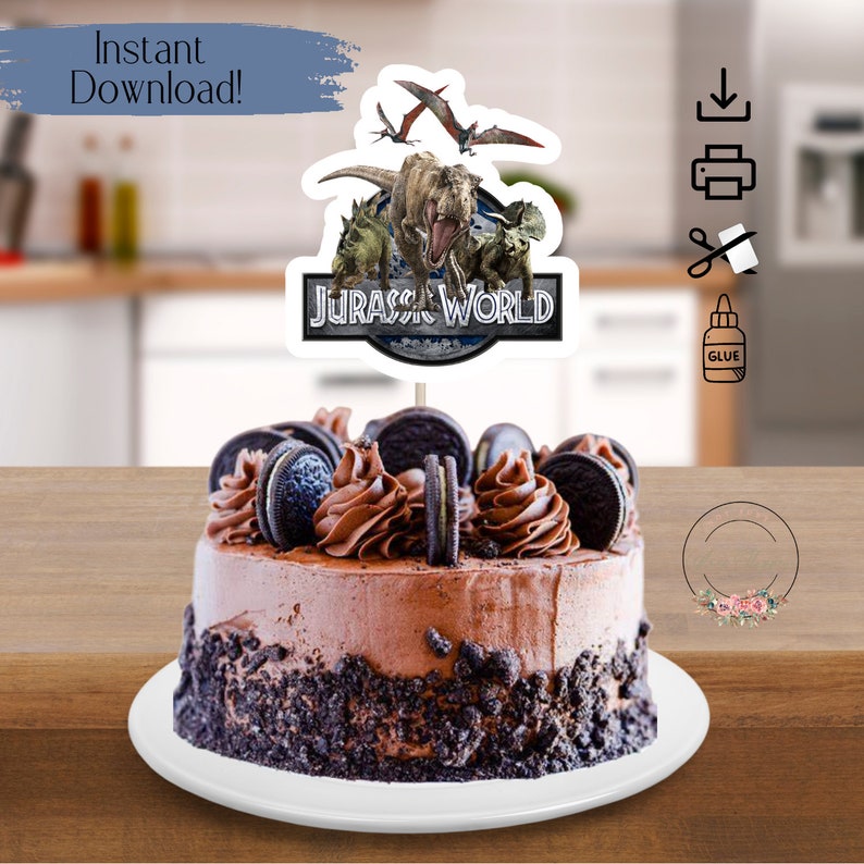 May include: A chocolate cake with Oreo cookie crumbs and frosting, topped with a Jurassic World cake topper featuring dinosaurs and the Jurassic World logo.