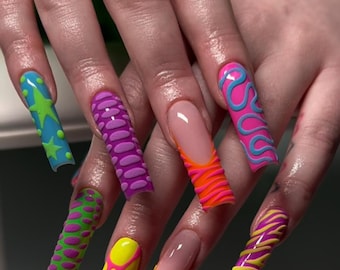 May include: Long, colorful, and patterned acrylic nails with different designs, including stars, swirls, and dots.
