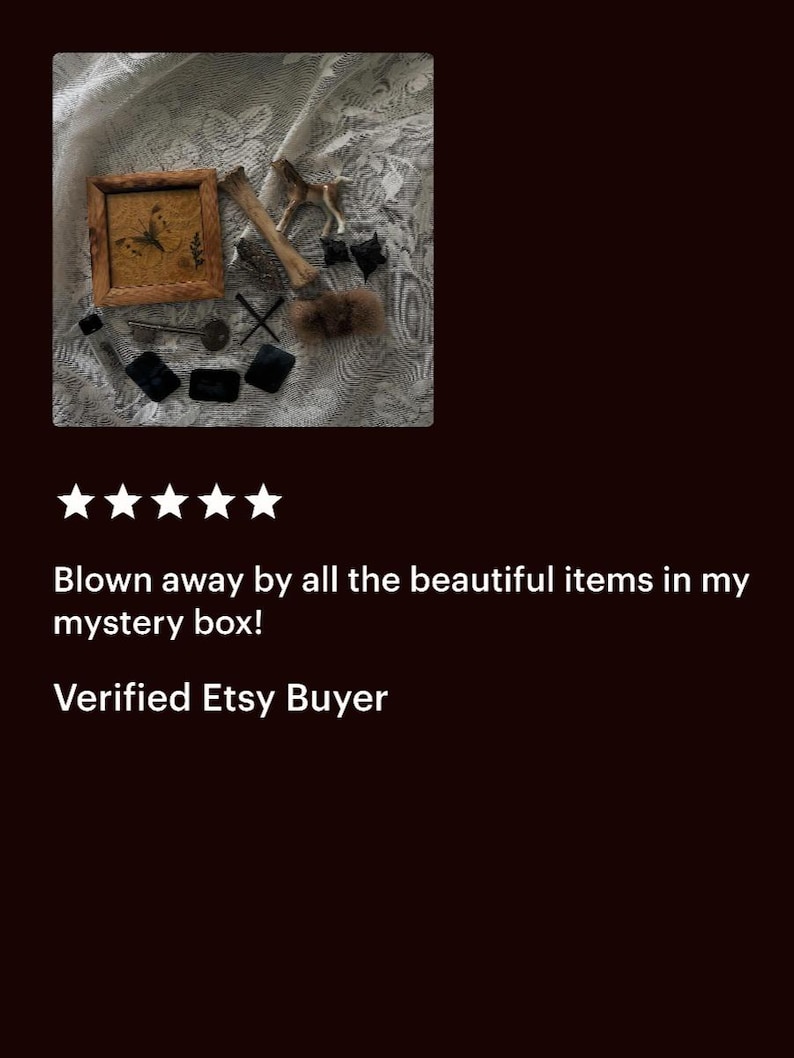 May include: An assortment of vintage-style items, including a small framed picture with a butterfly, a miniature horse figurine, a bone, keys, and small black objects, arranged on a textured surface.