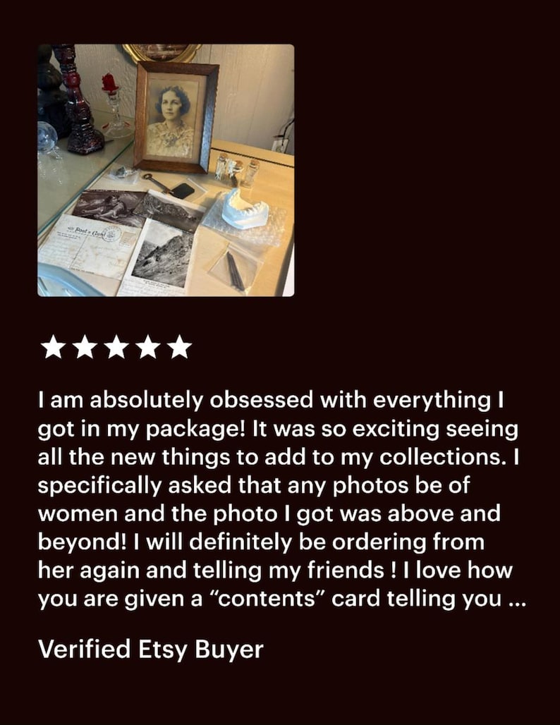 May include: An assortment of vintage items, including a framed portrait of a woman, postcards, and a small sculpture. The items are arranged on a wooden surface, with a customer review below.