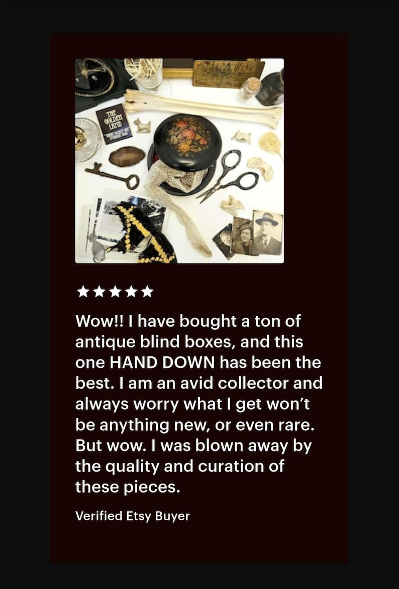 May include: An assortment of antique items, including a black round box with floral design, keys, scissors, and old photographs. The items are arranged on a white surface, suggesting a collection or curated display.