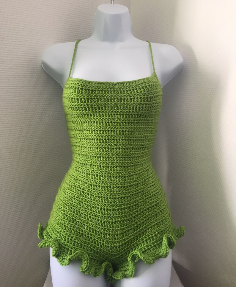 May include: A lime green crocheted bodysuit with a ruffled hem.