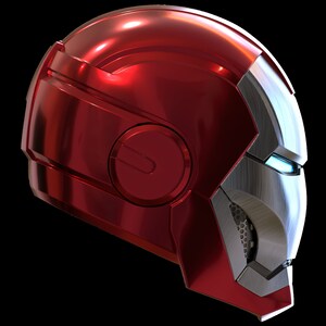 May include: A red and silver helmet with a futuristic design. The helmet has a large visor and a small, round window on the side.