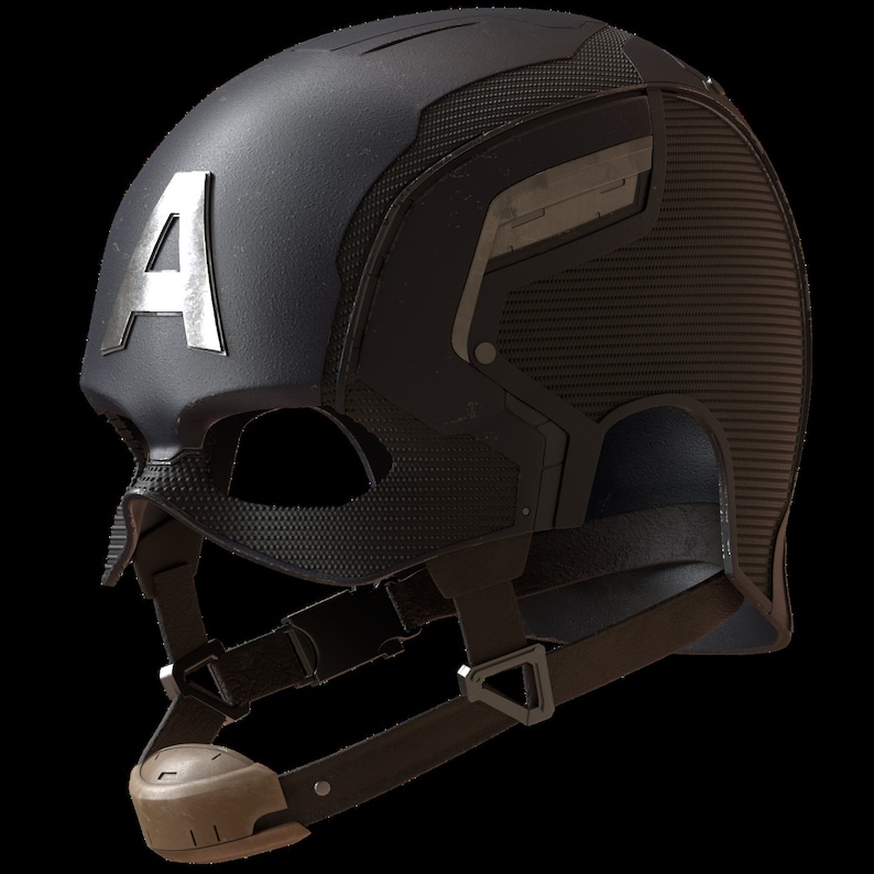 K&ouml;nnte beinhalten: Ein schwarzer Helm mit einem silbernen "A"-Emblem auf der Vorderseite. Der Helm hat eine strukturierte Oberfl&auml;che und einen Kinnriemen. Das Design umfasst einen Visierbereich und Seitenteile mit einem geometrischen Muster. Die Gesamt&auml;sthetik ist futuristisch und taktisch.