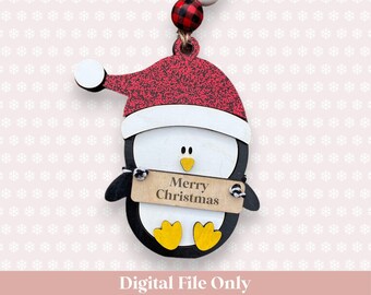 May include: A wooden penguin ornament with a red and white Santa hat, holding a sign that says "Merry Christmas".