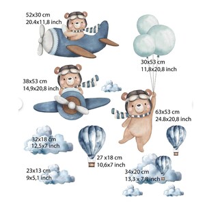 May include: A set of wall decals featuring brown bears in aviator gear, blue airplanes, hot air balloons, and clouds. Dimensions include 20.4x11.8 inches, 11.8x20.8 inches, 14.9x20.8 inches, 24.8x20.8 inches, 12.5x7 inches, 10.6x7 inches, 9x5.1 inches, and 13.3x7.8 inches.