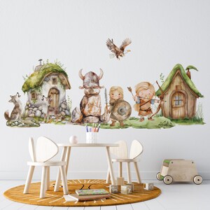 May include: A watercolor illustration of a whimsical forest scene with a viking warrior, a girl with a shield, a boy with a bow and arrow, and two houses with mossy roofs. The illustration is perfect for a nursery or child's room.