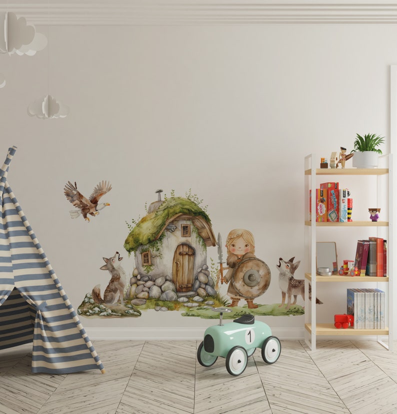 May include: A watercolor illustration of a girl with a shield and sword standing in front of a small stone house with a green roof. There are two wolves and an eagle in the scene. The illustration is printed on a white wall in a child's room.