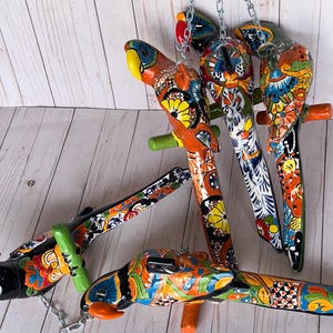 Hand-painted Talavera parrots, perfect for patios, gardens, or interiors.