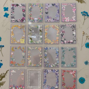 May include: Set of 15 clear plastic photo frames with different colourful borders decorated with various cute cartoon characters, flowers, and other designs. The frames are all the same size and are perfect for displaying photos or other small items.